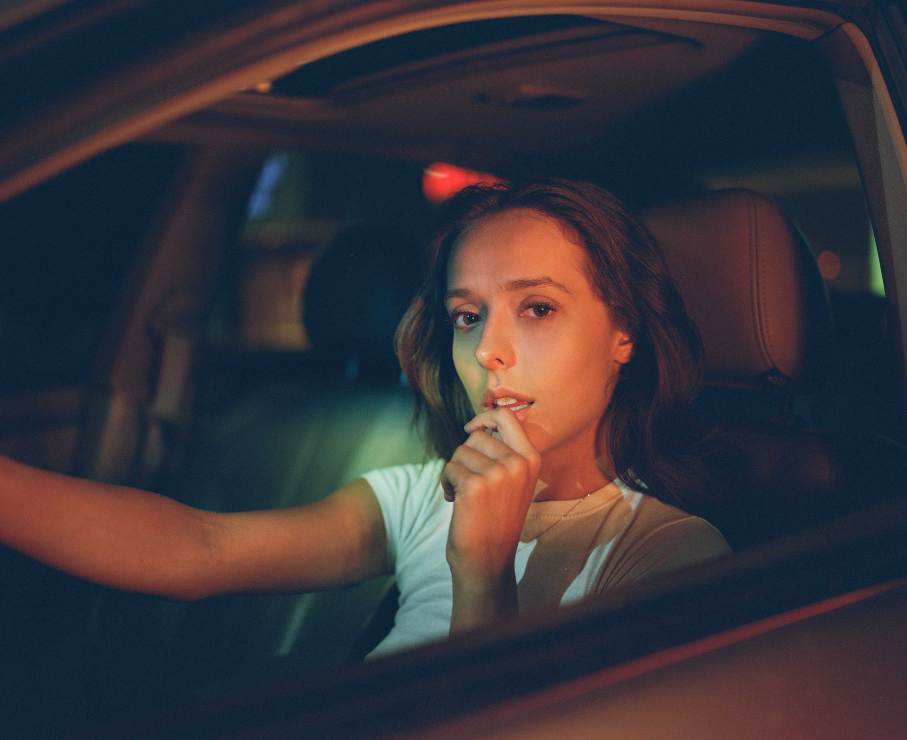 woman in car with red glow
